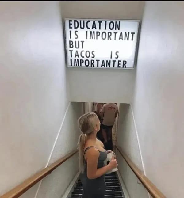 A sign reading "Education is important but tacos is importanter," prioritizing tacos over schooling.