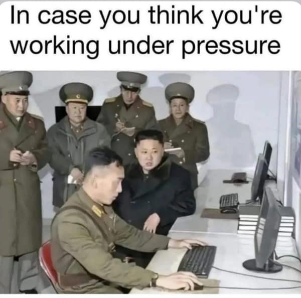 A funny work meme that puts your job stress in perspective by showing someone working under the watch of Kim Jong Un.