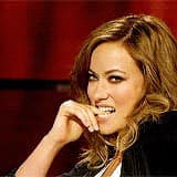 A reaction pic of Olivia Wilde biting her knuckle, used as a grey sweatpants season meme.