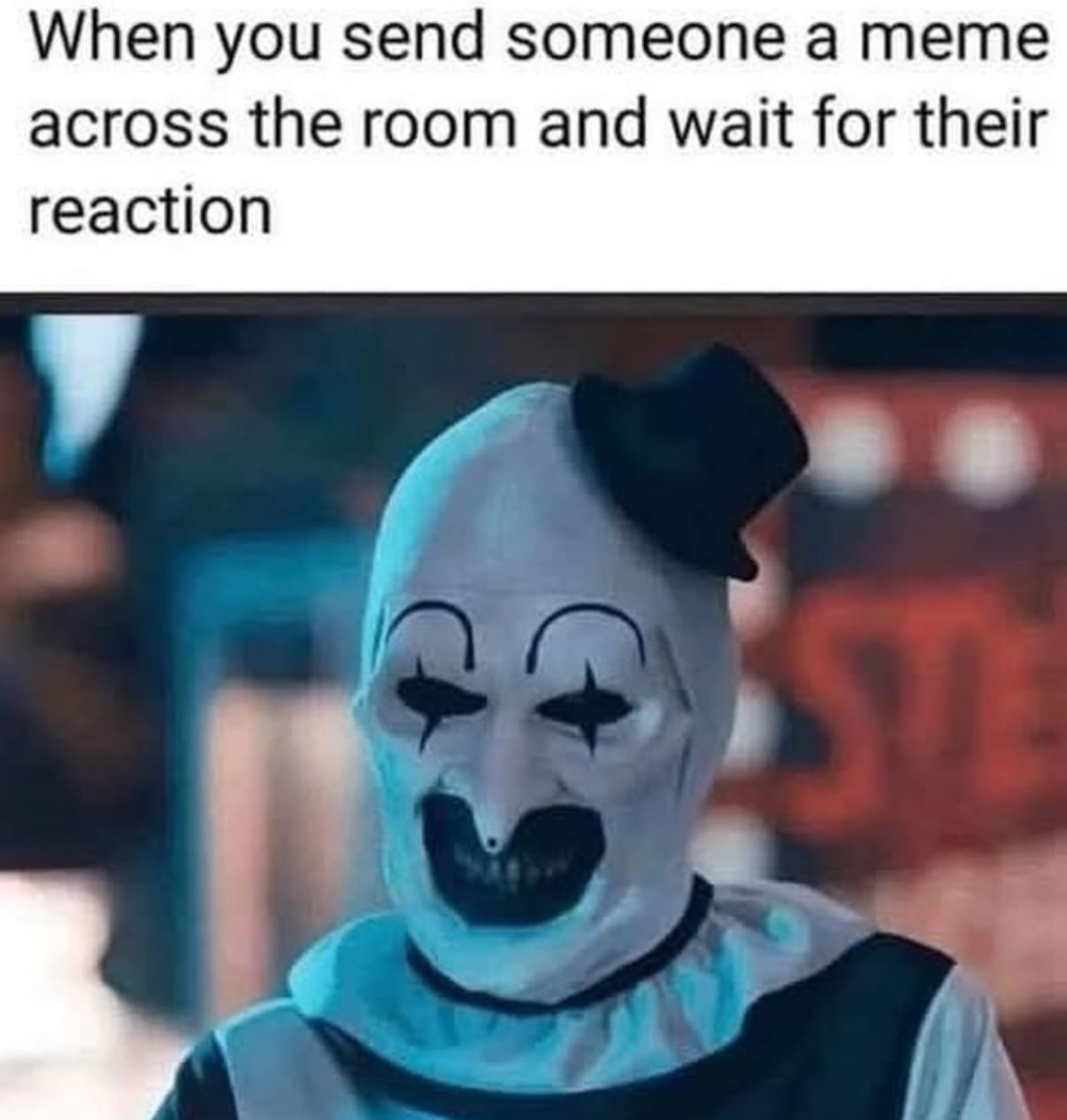 A funny horror movie meme using Art the Clown's creepy smile to show waiting for a meme reaction on Halloween.
