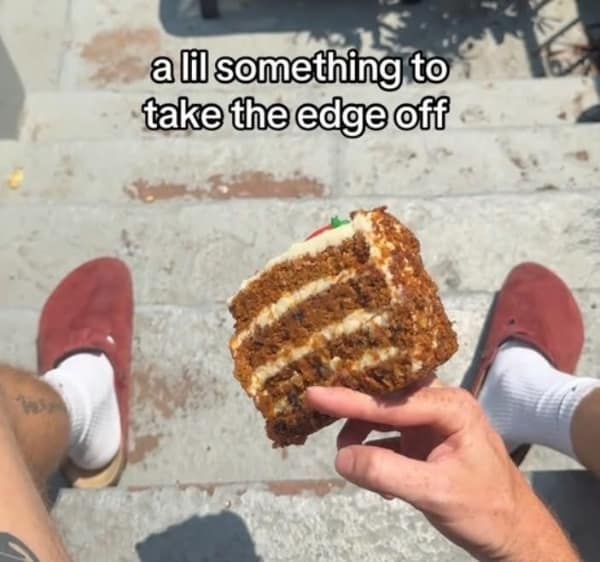 A funny lifemaxxing meme of a person holding a giant slice of carrot cake to "take the edge off."