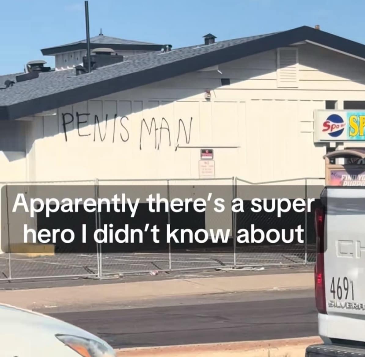 A funny meme showing graffiti of the name "Pnis Man" on the side of a building, framed as an unknown superhero.