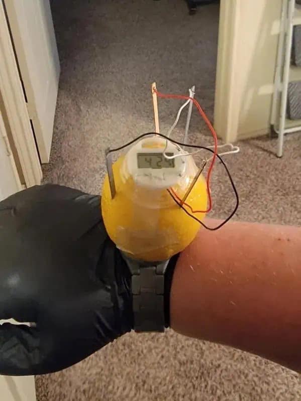 A cursed and hilarious meme image of a watch seemingly made out of a lemon and wires.