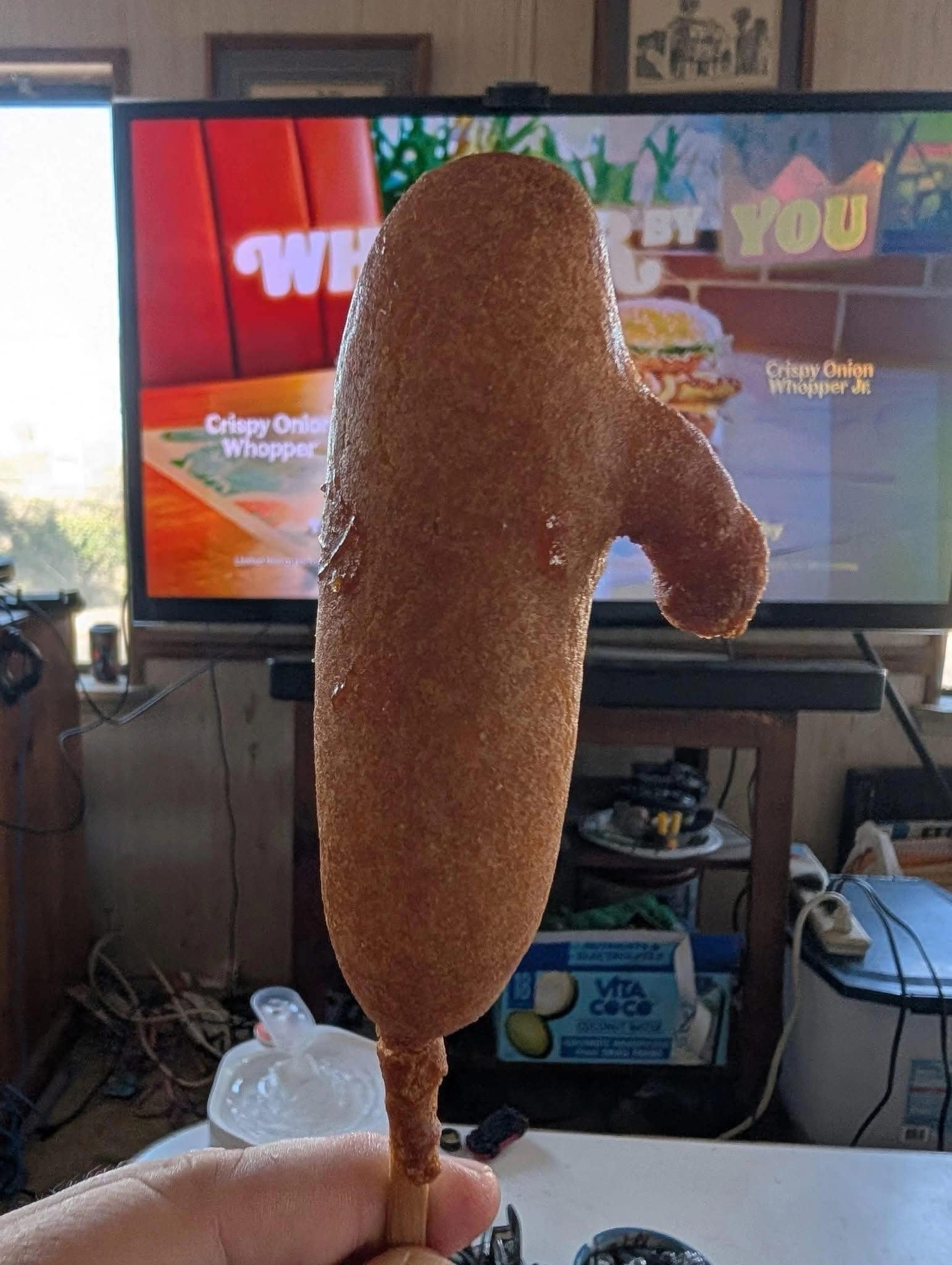 A hilarious meme of a corn dog that has a very unfortunate and phallic shape.