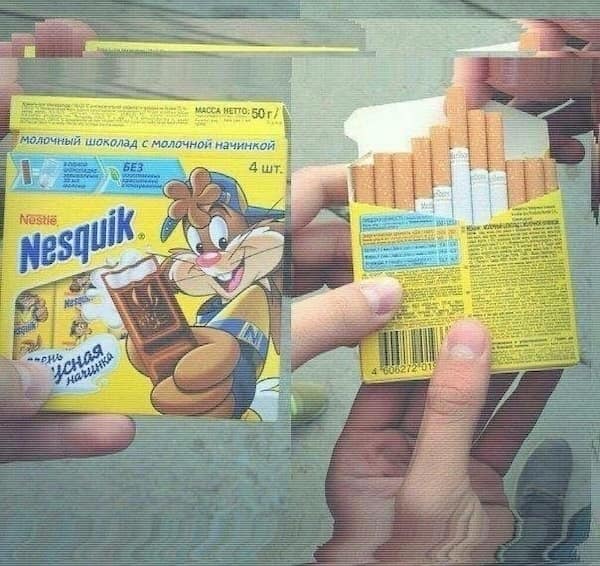 A clever and cursed image of a Nesquik chocolate box that has been modified to dispense cigarettes.