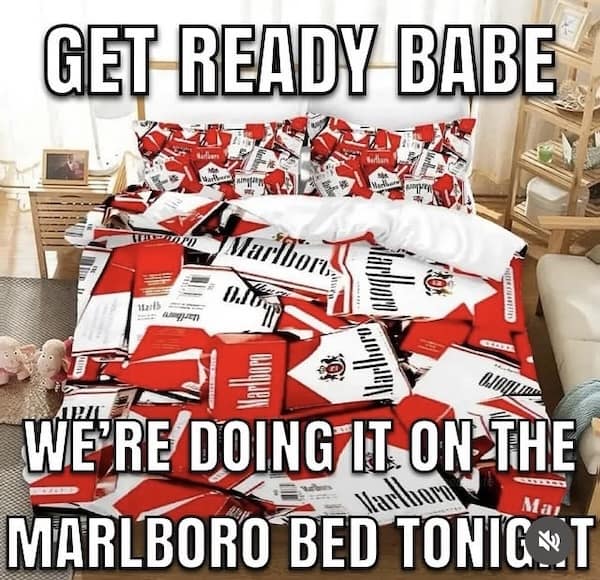 A funny and cursed meme showing a bed with a duvet cover and pillows designed like a Marlboro Red cigarette pack.