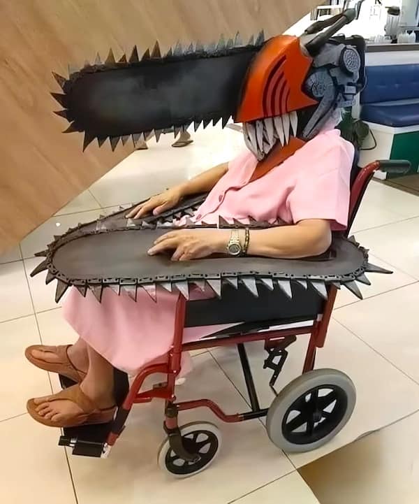 A cursed image of an elderly woman in a wheelchair with a 'Chainsaw Man' cosplay.