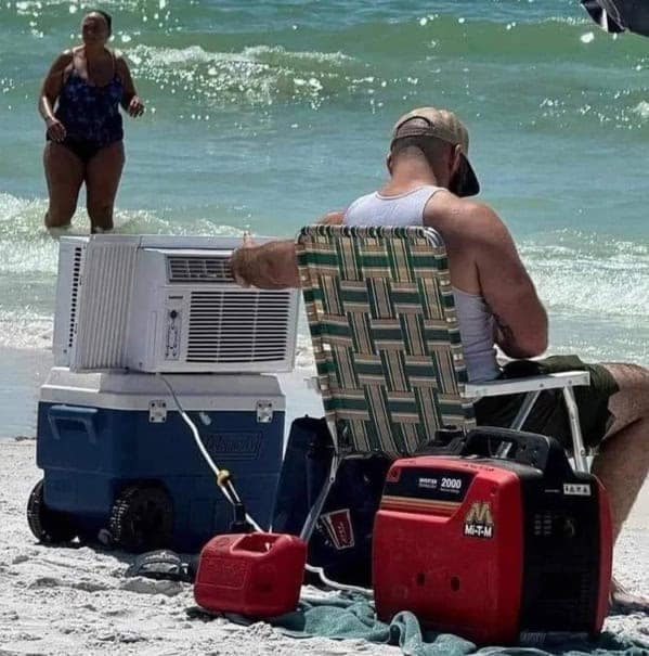 A masterpiece of redneck ingenuity, showing a man at the beach with a full window AC unit powered by a generator.
