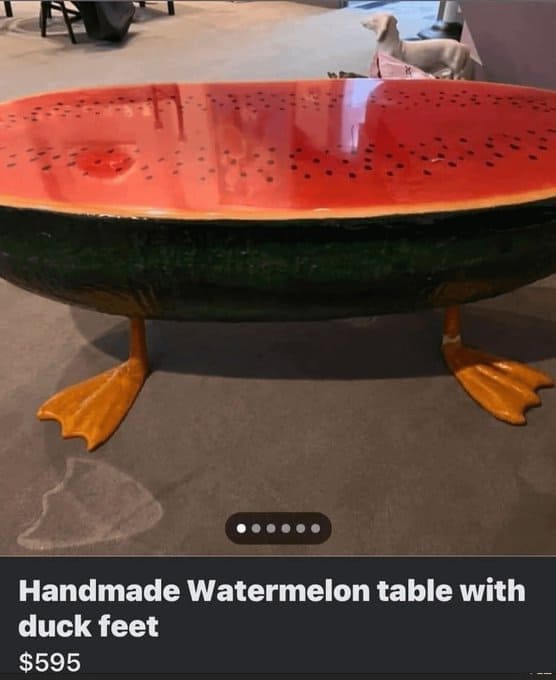 Resin coffee table shaped like a slice of watermelon standing on realistic duck feet.