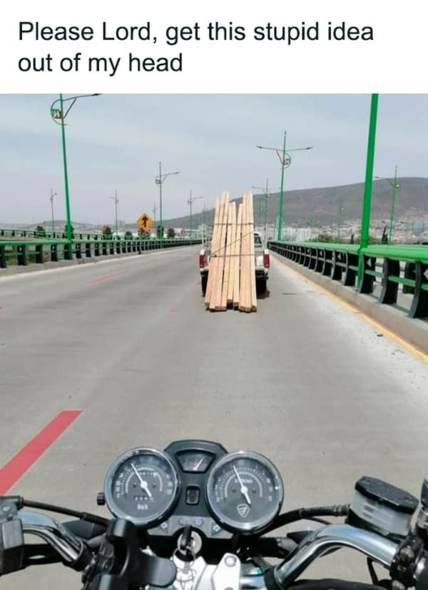 Funny meme from a motorcycle's point of view, looking at a truck's load of wood as a ramp.