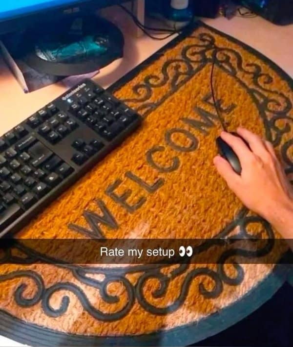 A classic "Rate my setup" old meme showing a gamer using a "Welcome" doormat as a mousepad.