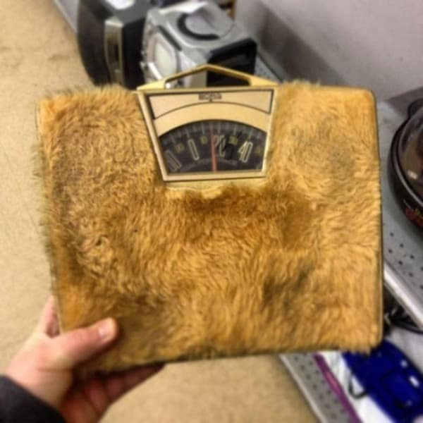Vintage bathroom scale covered in unsettling brown shag carpet fur.