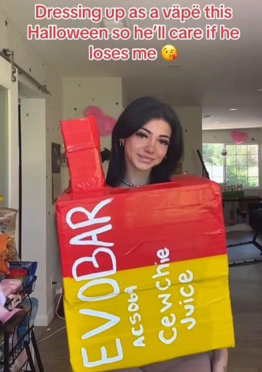 A funny TikTok screenshot of a woman in a homemade "vape" Halloween costume.
