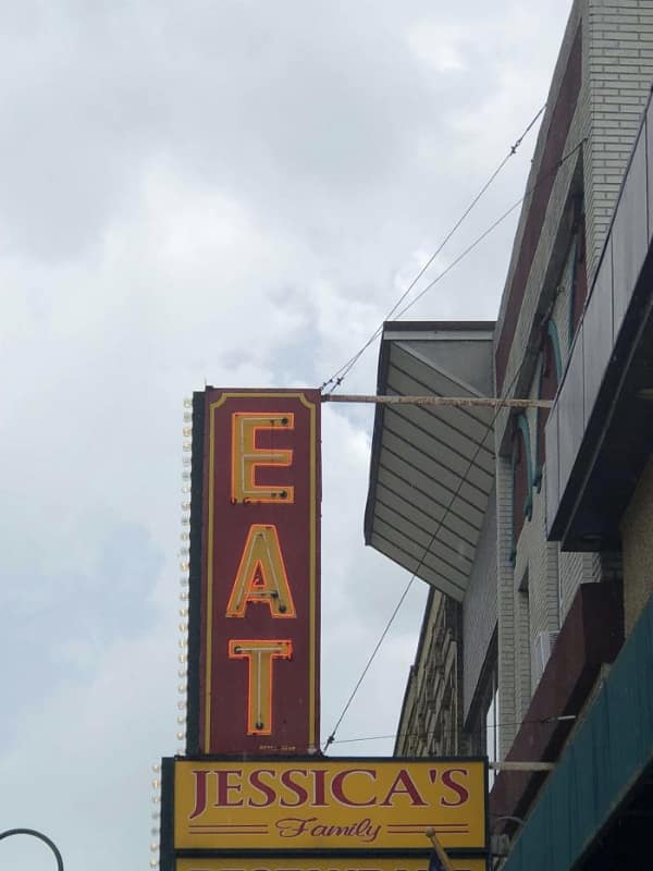 A signage design fail that reads "Eat Jessica's Family" due to vertical placement.