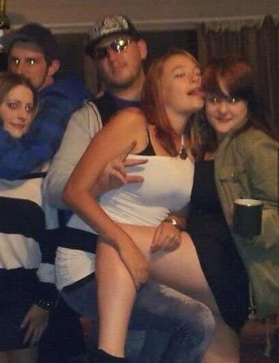 Funny awkward party photo where a girl's hand placement looks like something else entirely.