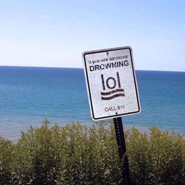 A beach sign for "drowning" where the stick figure symbol looks exactly like the text "lol."