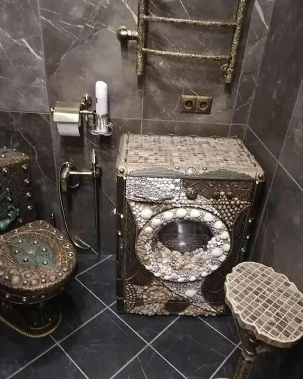 A diy fail showing a washing machine covered in seashells and mosaic tiles.
