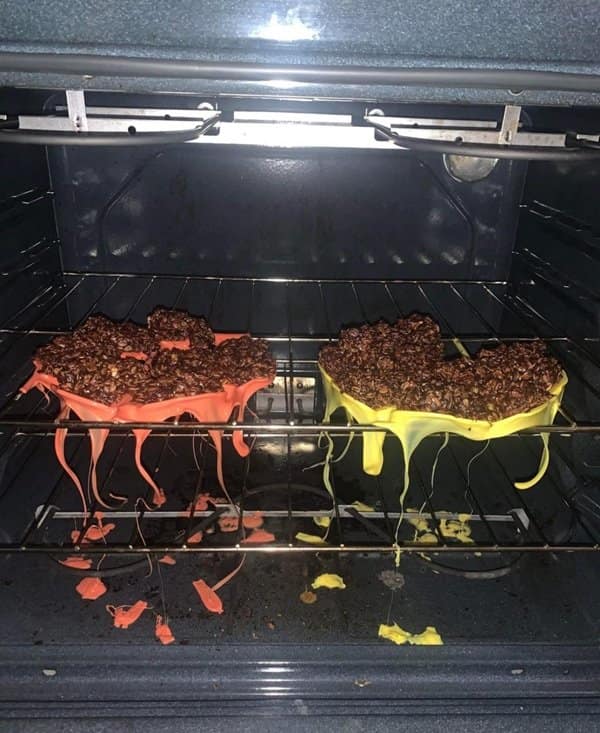A funny fail in the kitchen, showing two silicone baking trays melted completely through the oven rack
