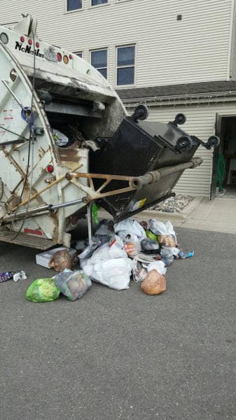 A funny fail where a garbage truck spills all the trash on the ground after the dumpster breaks.
