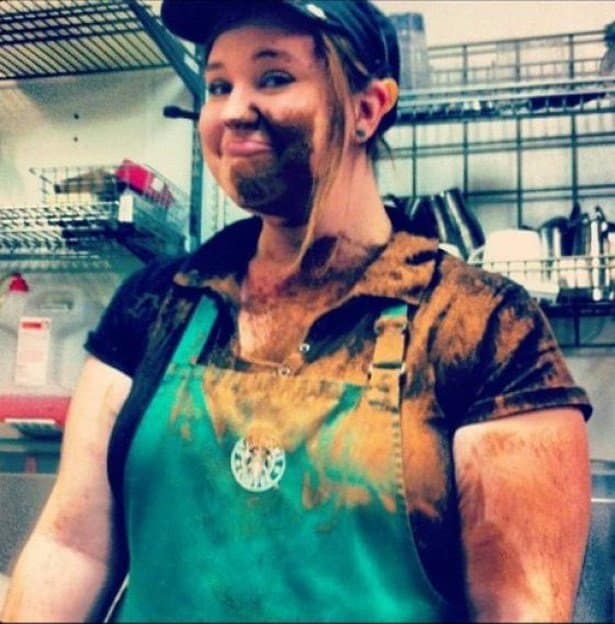 A funny fail of a Starbucks barista smiling after being covered in coffee, mocha, or cinnamon powder.
