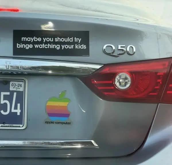 Car bumper sticker reading maybe you should try binge watching your kids next to Apple logo.