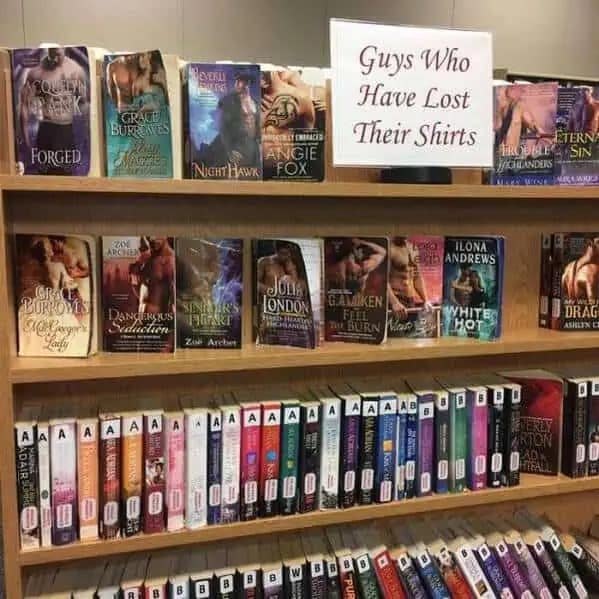 Library display sign labeling romance novels as guys who lost their shirts funny memes.