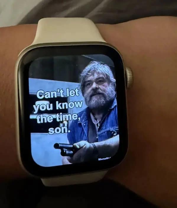 Apple Watch face displaying man with gun refusing to tell time funny memes.