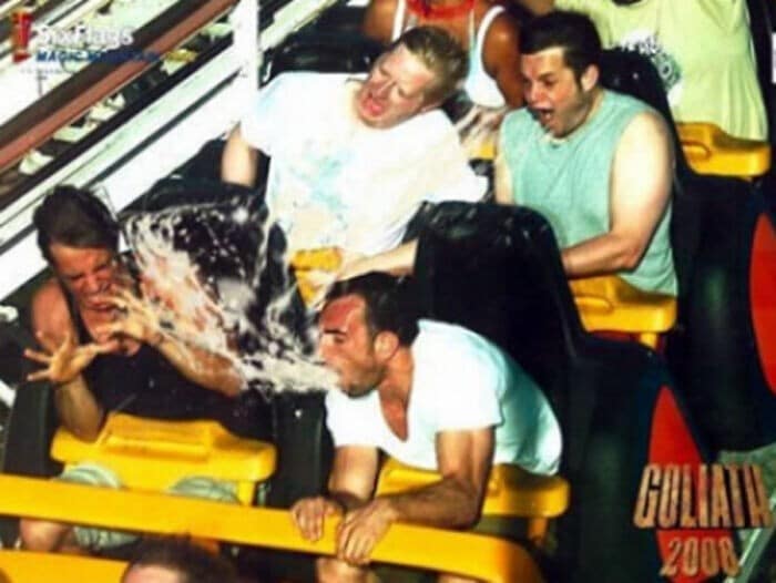 A legendary funny rollercoaster picture showing a man projectile vomiting onto the rider directly in front of him.