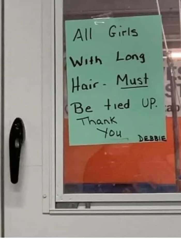 A funny sign from "Debbie" with unfortunate phrasing about tying up girls with long hair.