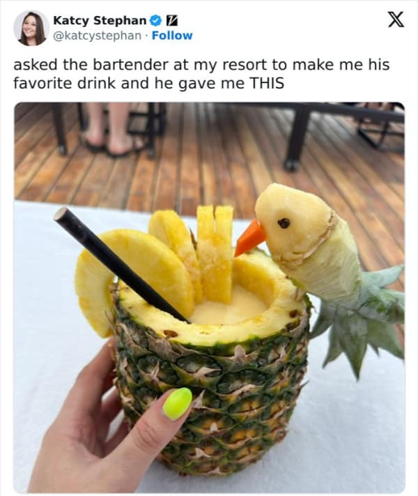 A tweet showing a bartender's amazing "favorite drink": a cocktail served in a pineapple, with a parrot carved from the pineapple top.