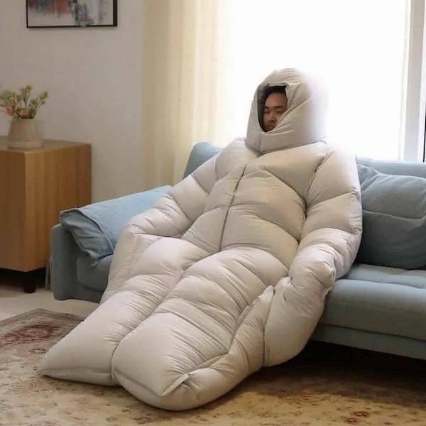 Funny meme of a man sleeping in a giant duvet suit