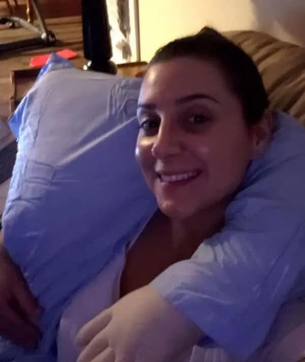 Woman hugging a body pillow made of a shirt and glove in a memes about being single.