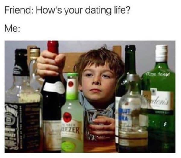 Child sitting at a table surrounded by alcohol bottles in a memes about being single.