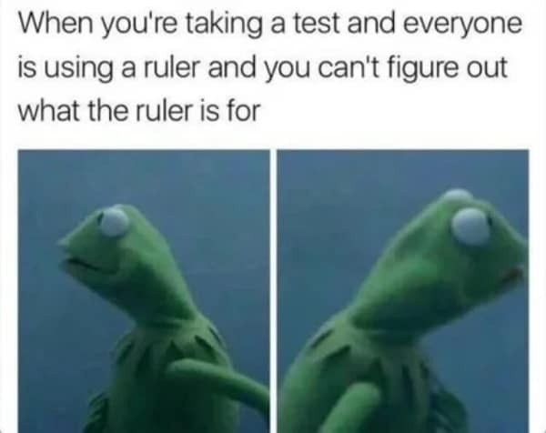 Confused Kermit looking around while other students use rulers during a test.