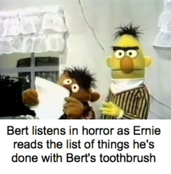 Bert looking horrified while Ernie reads a list of things done with his toothbrush.