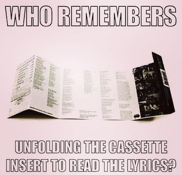 A 90s meme for music lovers: unfolding a cassette tape insert to read the lyrics.
