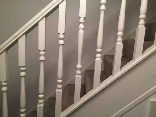 A white staircase banister that is ruined by one spindle being installed upside down.