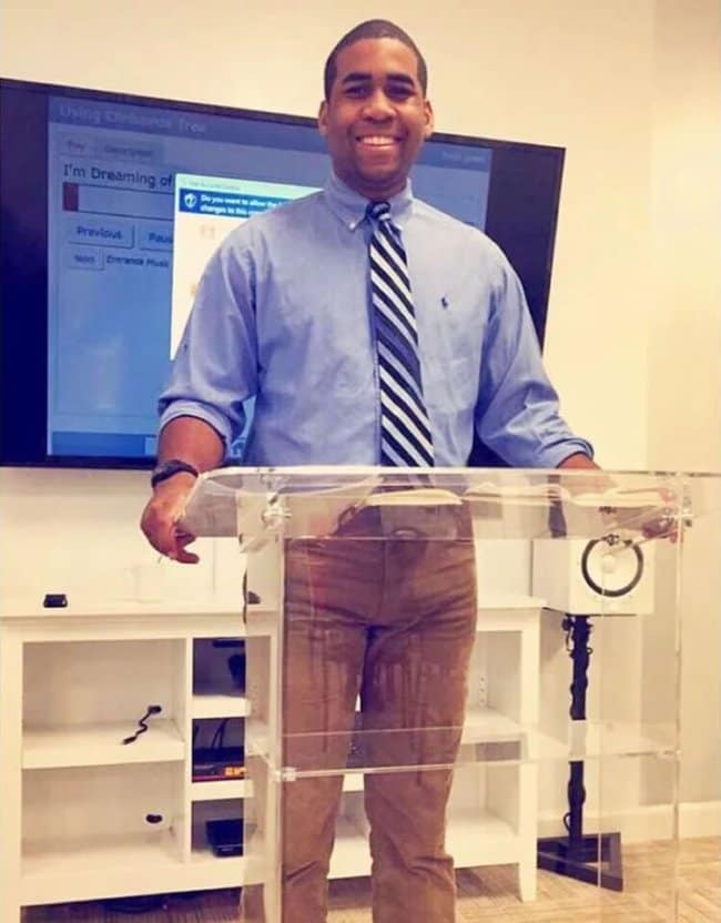 Unfortunate optical illusion of a man at a clear lectern where reflections make it look like he peed his pants.