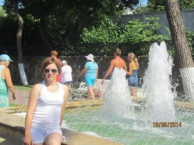 Perfectly timed photo optical illusion of a fountain lining up with a man, making it look like a water dress.