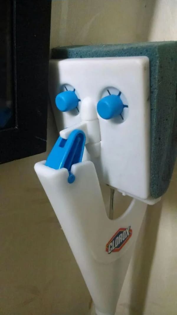 Clorox toilet wand holder looking like a cartoon face with blue eyes and tongue.