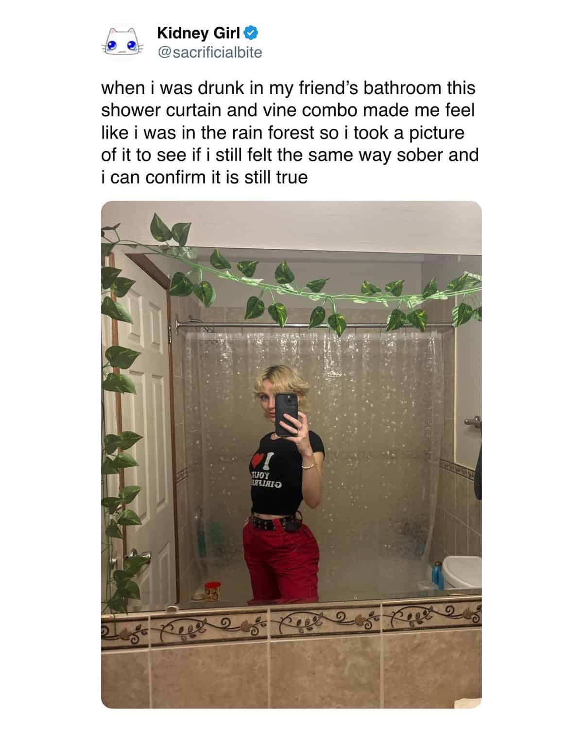 Woman taking a bathroom selfie to confirm her vine shower curtain still looks cool sober.