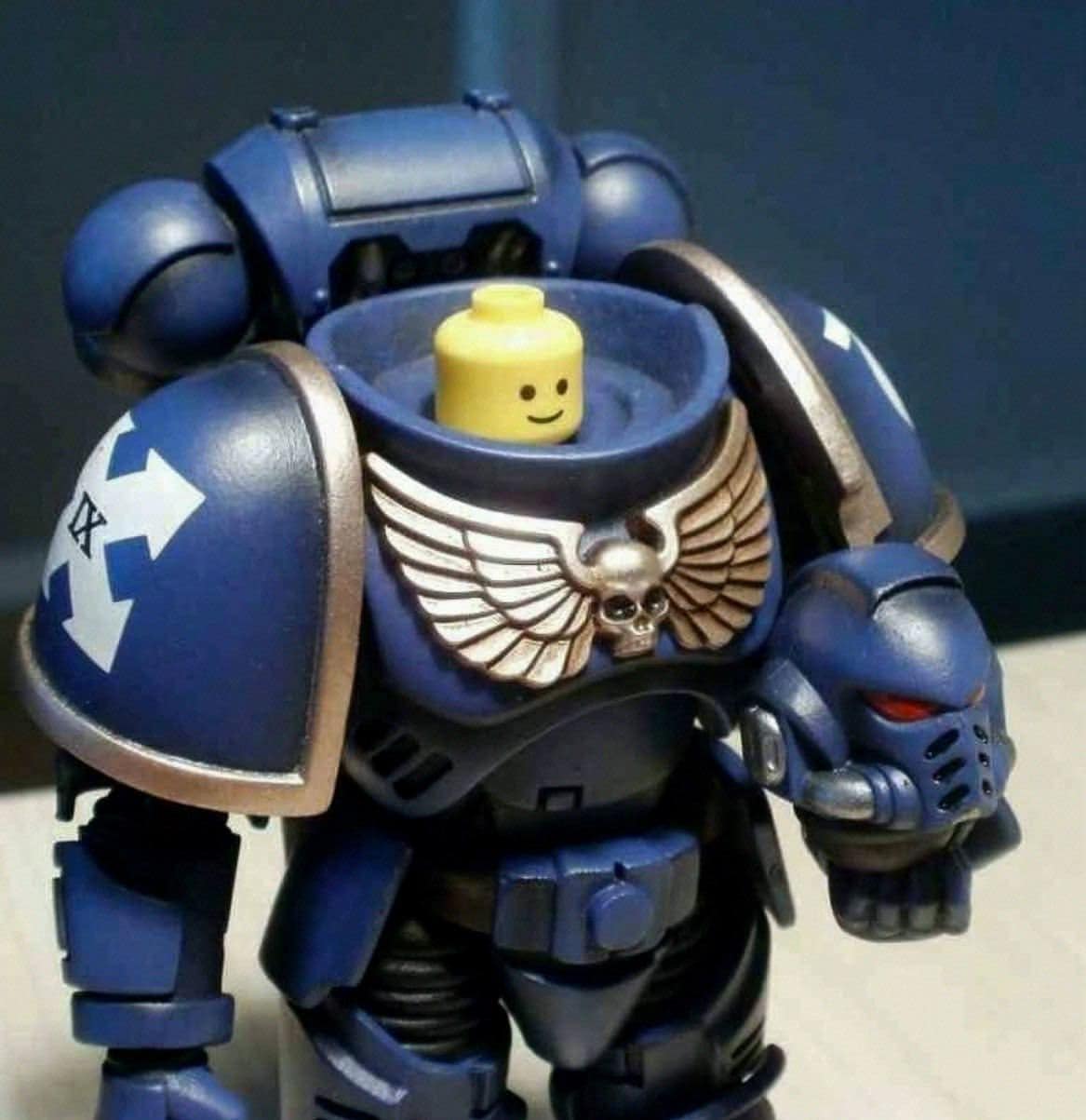 A warhammer 40k meme showing a blue Space Marine action figure with a smiling yellow Lego head inside the armor.