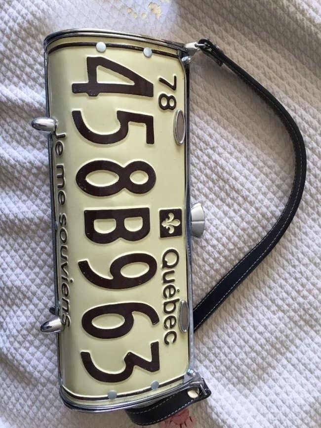 A unique, handmade purse or handbag crafted from a bent vintage 1978 Quebec license plate.