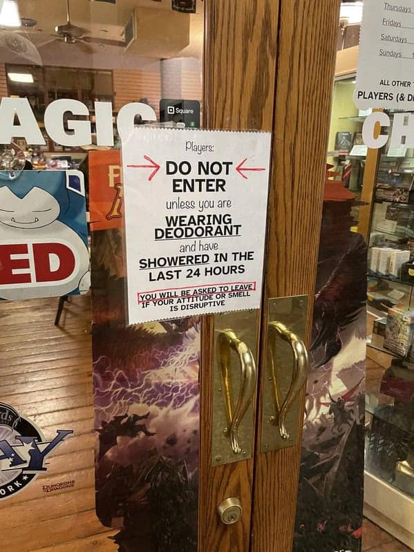 A funny sign on a game store door, telling players they can't enter unless they have showered and wear deodorant.