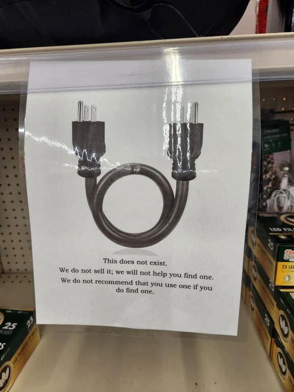 A funny hardware store sign showing a non-existent male-to-male power cord, saying, "This does not exist."