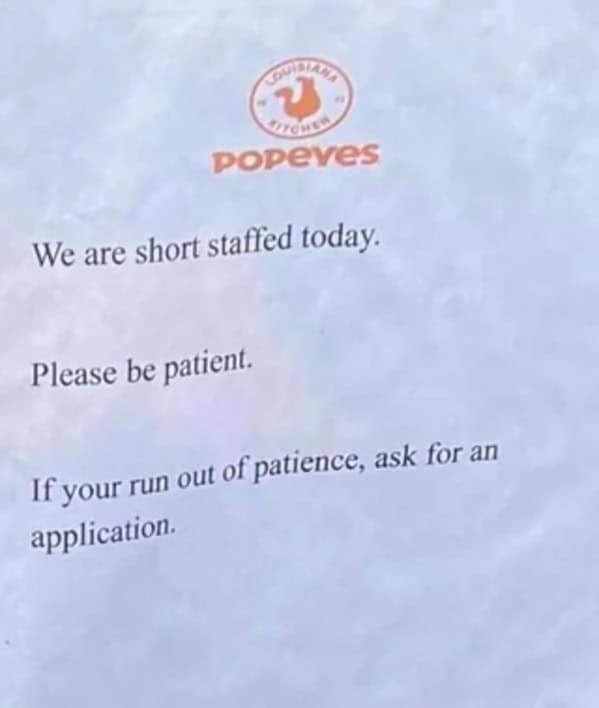 A sassy Popeyes sign telling impatient, short-staffed customers to "ask for an application."
