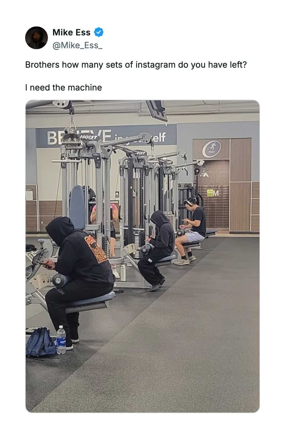 Tweet mocking gym goers sitting on machines scrolling through Instagram instead of lifting.