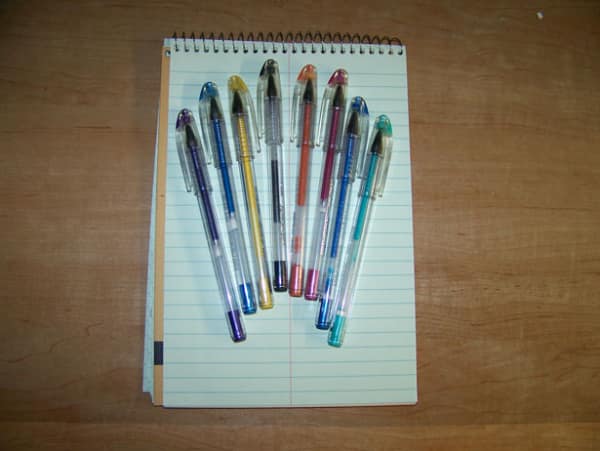 A 90s toy photo showing a collection of milky gel pens on a notepad.