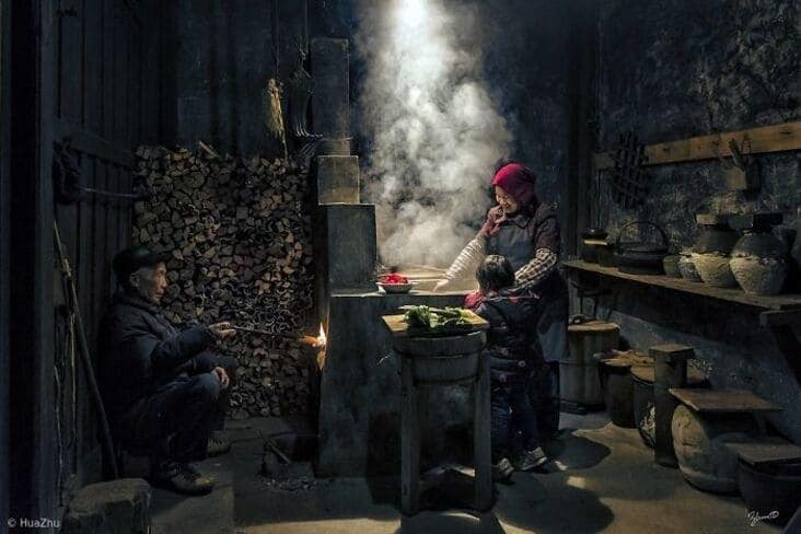 An accidental renaissance painting image of a family cooking in a dark rustic kitchen with dramatic lighting and steam