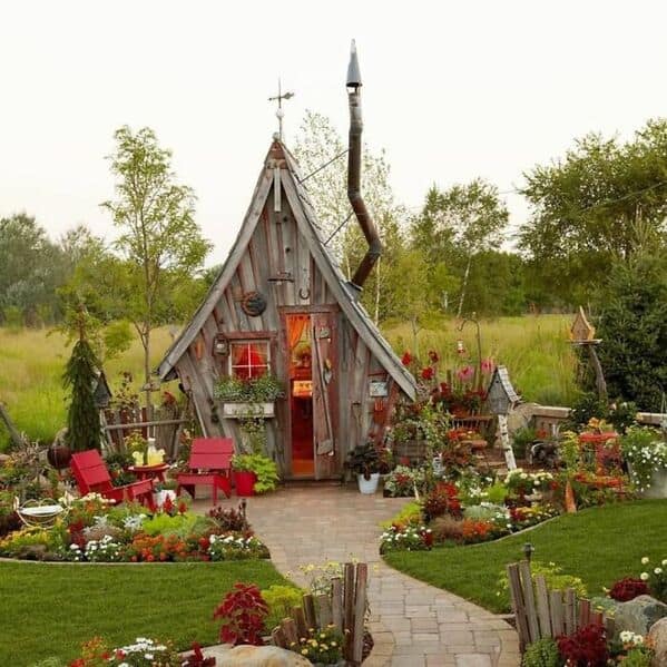 An amazing woodworking build of a whimsical tiny house with a crooked chimney